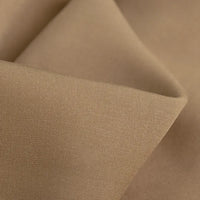 Close-up of Longan Craft’s 100 Rayon Fabric By The Yard, showing its light brown, breathable viscose with a smooth texture, fine matte weave, and soft folds—ideal for dressmaking and garment projects.