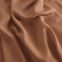A close-up of Longan Craft’s 100 Rayon Fabric by the Yard shows its light brown, silky viscose material with soft folds, slightly sheer texture, subtle sheen, and smooth drape—ideal for breathable dressmaking projects.