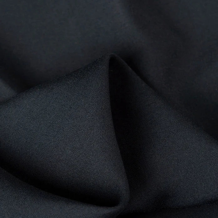 A close-up of Longan Craft's 100% Rayon Fabric By The Yard reveals its smooth, soft texture and subtle sheen—ideal as a breathable solid color viscose material for comfortable dressmaking and clothing projects.