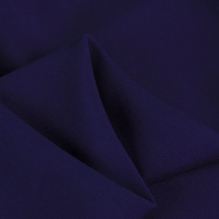 A close-up of Longan Craft’s 100 Rayon Fabric By The Yard highlights its solid navy color, smooth texture, subtle sheen, and lightweight feel—perfect for soft rayon dressmaking and clothing projects.