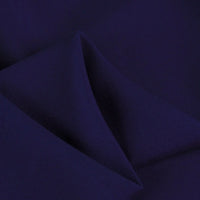 A close-up of Longan Craft’s 100 Rayon Fabric By The Yard highlights its solid navy color, smooth texture, subtle sheen, and lightweight feel—perfect for soft rayon dressmaking and clothing projects.