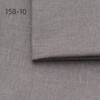 A close-up of Longan Craft Faux Linen Upholstery Fabric in grey polyester with a folded edge shows its texture. The number 158-10 appears in black on the upper left corner.