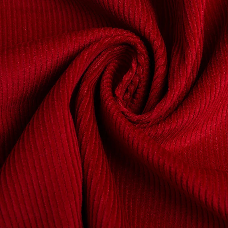 Close-up of Longan Craft's 11 Wales Cotton Corduroy Fabric By The Yard, a solid thick corduroy in rich red. Made from 100% cotton, its fine vertical lines and soft texture make it perfect for apparel projects.