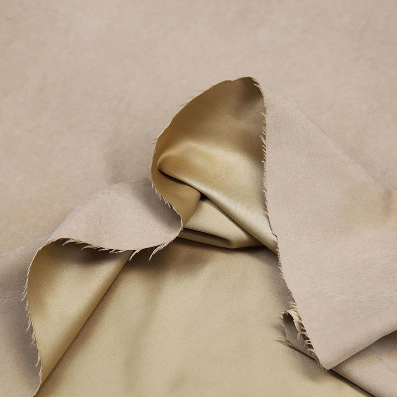 A close-up of Longan Craft Multi Color Microsuede Polyester Peachskin Fabric by the yard, showing its brushed peach skin texture, with glossy and matte sides visible and frayed edges for a cozy clothing material.