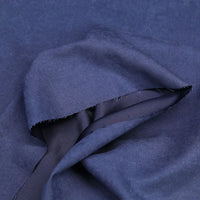 A close-up of Longan Craft’s Multi Color Microsuede Polyester Peachskin Fabric by the yard, featuring brushed peach skin texture, a folded edge, and unfinished seam with loose threads. Perfect cozy material for clothing.