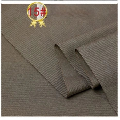 A close-up of Longan Craft’s Twill Cotton Lyocell Fabric By The Yard, a comfy and breathable solid color textile for shirts with a smooth brown finish, neatly folded. Top left shows a gold ribbon icon with 15# in a red circle.