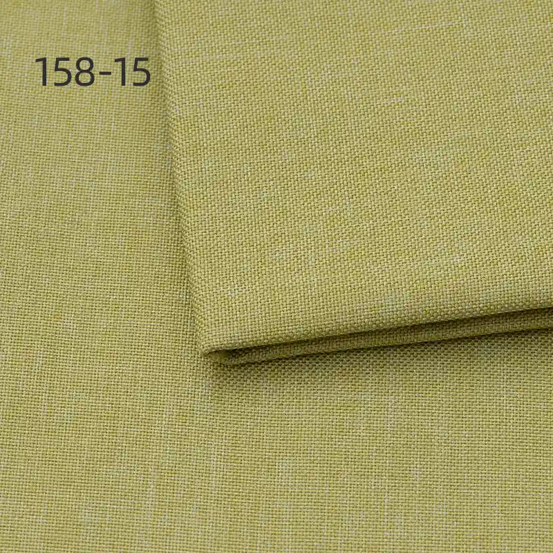 Close-up of Longan Craft Faux Linen Upholstery Fabric in light yellow-green polyester, folded section on top. Code 158-15 appears in the top left. Ideal for upholstering furniture, reupholstering chairs, sofas, or curtains by the yard.