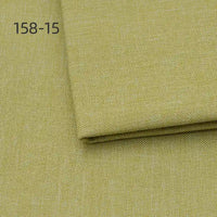 Close-up of Longan Craft Faux Linen Upholstery Fabric in light yellow-green polyester, folded section on top. Code 158-15 appears in the top left. Ideal for upholstering furniture, reupholstering chairs, sofas, or curtains by the yard.
