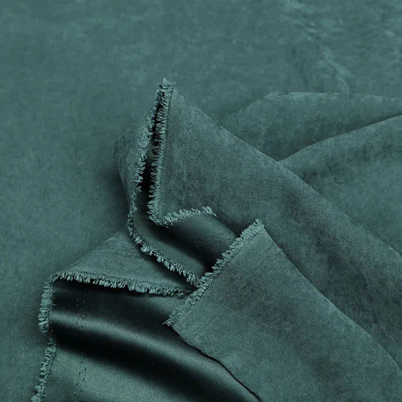 Longan Craft Multi Color Microsuede Polyester Peachskin Fabric by the yard features a brushed peach skin texture and cozy material, perfect for clothing, shown loosely folded to display its softness and thickness.