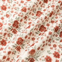 Longan Craft’s 16 Wale Floral Printed Corduroy Fabric by the yard features red flowers and green leaves on a white fine-wale textured base, perfect for casual wear with its premium, colorful, and slightly wrinkled corduroy material.