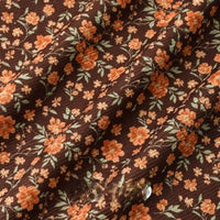 Longan Craft 16 Wale Floral Printed Corduroy Fabric By The Yard features colorful orange and yellow flowers with green leaves on fine ribbed corduroy, offering a soft drape and gentle texture—ideal for casual wear and creative projects.