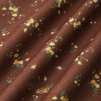 Close-up of Longan Craft 16 Wale Floral Printed Corduroy Fabric—premium, soft-textured material with small yellow and green flowers and fine ridges, perfect for casual wear and sold by the yard.