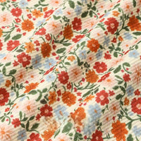 Close-up of Longan Craft’s 16 Wale Floral Printed Corduroy Fabric by the yard, showcasing colorful orange, red, blue, and green floral patterns on fine textured corduroy, gathered in soft folds—ideal for casual wear projects.