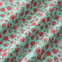 Longan Craft’s 16 Wale Floral Printed Corduroy Fabric By The Yard features a colorful fine wale corduroy with small red and pink flowers on a light blue, ribbed surface—premium corduroy textile ideal for casual wear.