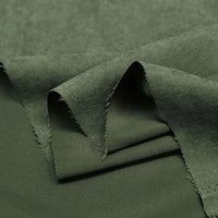 A close-up of Longan Craft’s Multi Color Microsuede Polyester Peachskin Fabric shows its soft, brushed peach skin texture with layered, slightly frayed edges—ideal for cozy clothing by the yard.