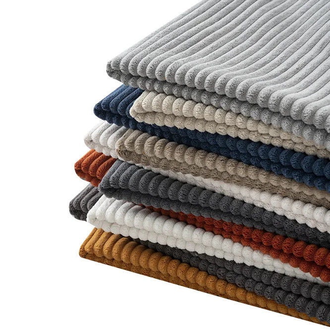 A neatly stacked pile of Longan Craft's 2.5 Wale Multicolor Polyester Corduroy Fabric by the yard—perfect for upholstery projects—in shades like grey, beige, blue, brown, mustard, and white arranged in alternating layers.