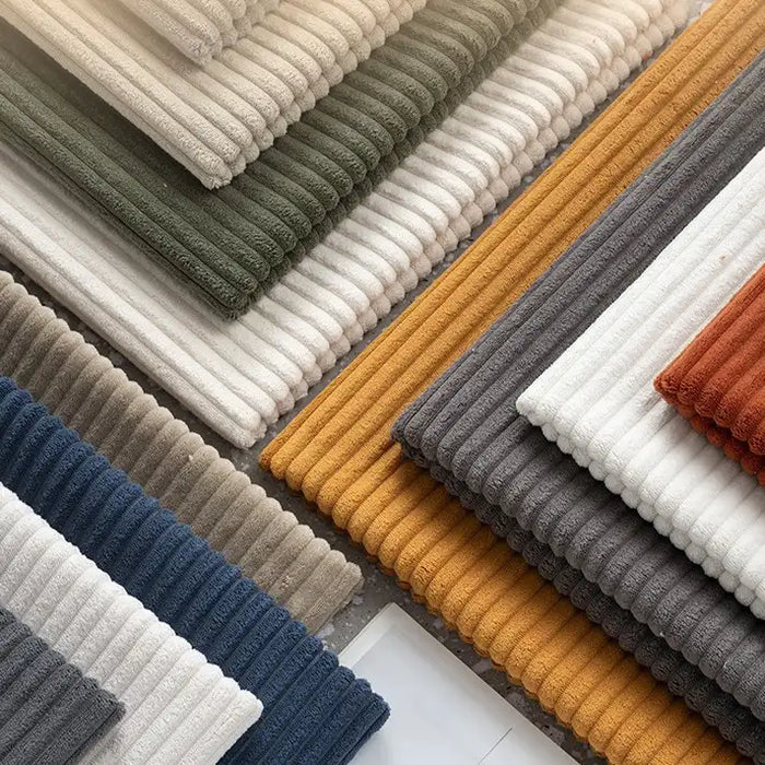 Neatly arranged in a geometric pattern, Longan Craft's 2.5 Wale Corduroy Fabric By The Yard features multicolor polyester corduroy—white, grey, mustard yellow, navy blue, olive green, taupe, and burnt orange—ideal for upholstery.