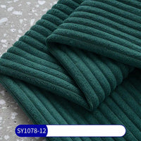 Longan Craft's 2.5 Wale Corduroy Fabric By The Yard, a multicolor polyester corduroy for upholstery, is neatly folded on a speckled grey surface with a blue SY1078-12 label at the bottom.
