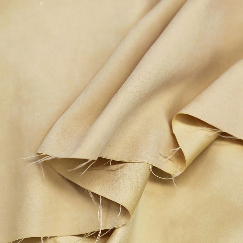 A close-up of Longan Craft Multi Color Microsuede Polyester Peachskin Fabric shows its smooth brushed texture, unfinished frayed edges, and gentle folds—cozy material perfect for clothing by the yard.