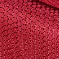 Close-up of Longan Craft's 210D Honeycomb Pattern Oxford Fabric By The Yard, featuring a colorful PU-coated, waterproof finish—perfect for outdoor use with its textured, geometric look and red hue.