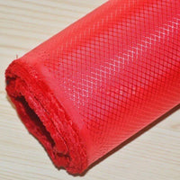 A close-up of Longan Craft’s 210D Honeycomb Pattern Oxford Fabric By The Yard, featuring a diamond grid design and vibrant red color, shown on a light wood surface. This colorful PU coated, waterproof fabric is ideal for outdoor use.