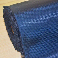 A close-up of Longan Craft's 210D Honeycomb Pattern Oxford Fabric by the yard, featuring a dark blue PU-coated, waterproof material with a subtle grid pattern and fringed edge, displayed on a light wooden surface.