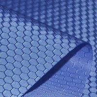 A close-up of Longan Craft’s 210D Honeycomb Pattern Oxford Fabric By The Yard, a colorful PU-coated, waterproof material with a repeating hexagonal design—flexible and ideal for outdoor use.