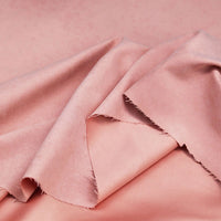 A close-up of Longan Craft’s Multi Color Microsuede Polyester Peachskin Fabric By The Yard, featuring a soft, brushed peach skin texture with gentle folds and unfinished edges—ideal cozy material for clothing.