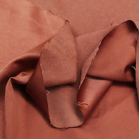 A close-up of Longan Craft’s Multi Color Microsuede Polyester Peachskin Fabric by the yard shows its brushed peach skin texture, soft sheen, and visible folds—ideal cozy peachskin material for clothing.