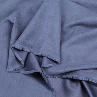 Close-up of Longan Craft's Multi Color Microsuede Polyester Peachskin Fabric, showing its cozy, brushed peach skin texture and slightly textured surface with raw, frayed edges, draped in loose layers—ideal for clothing by the yard.