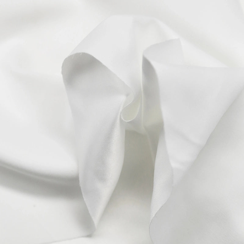 A close-up of Longan Craft Multi Color Microsuede Polyester Peachskin Fabric By The Yard shows its brushed peach skin texture and cozy, soft folds—perfect for clothing.