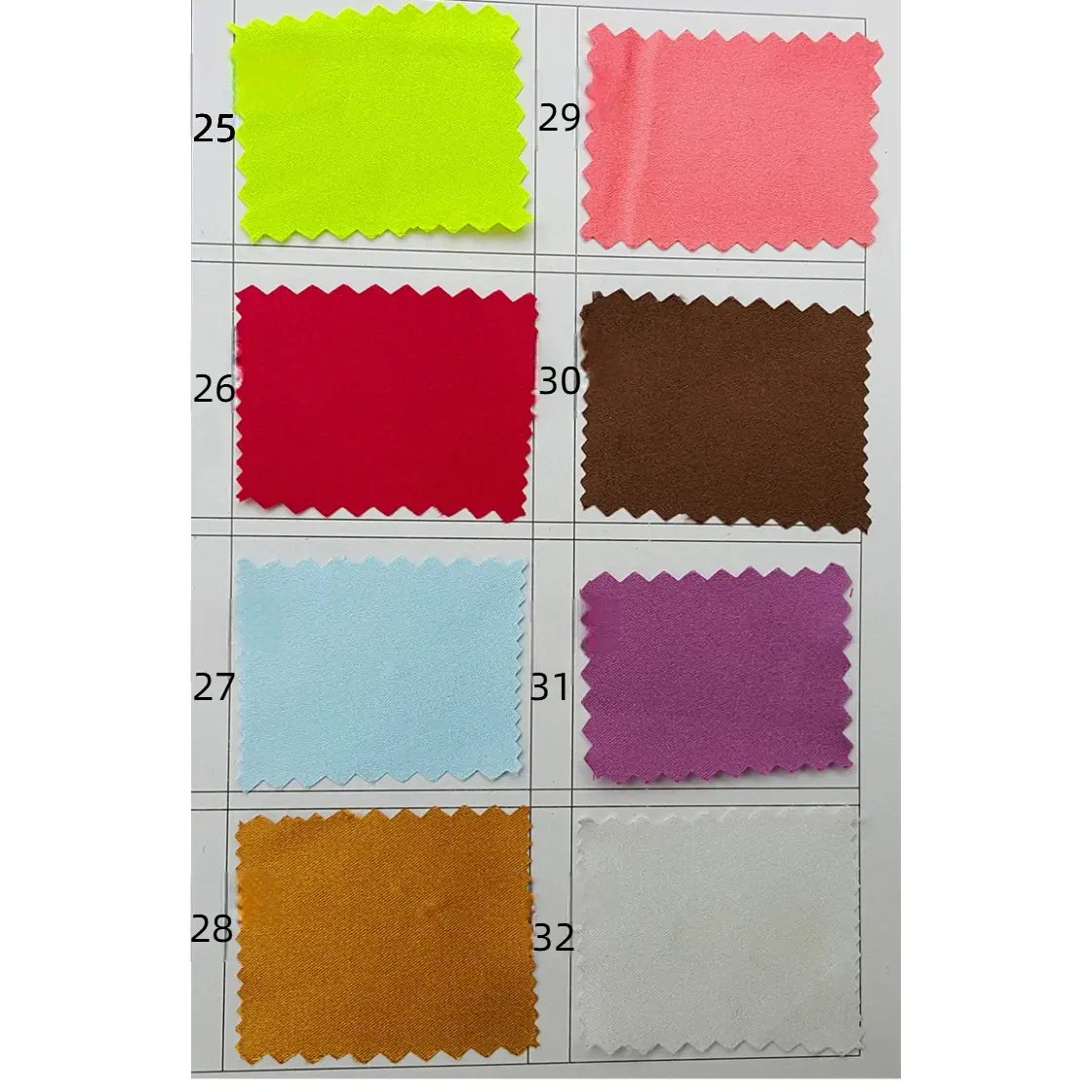 A Longan Craft swatch card shows eight silky polyester satin fabric samples (25–32) in neon yellow, coral, red, brown, light blue, purple, orange, and white. Each has zigzag edges. Perfect for apparel by the yard.
