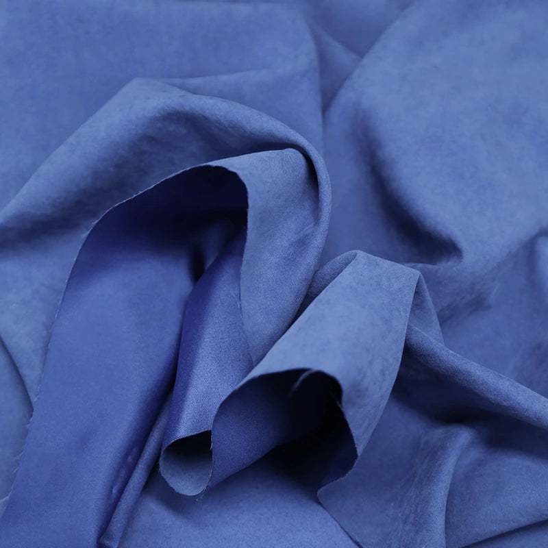 Close-up of Longan Craft Multi Color Microsuede Polyester Peachskin Fabric, showing its soft, brushed texture and subtle folds that create gentle shadows—perfect cozy peachskin material for clothing by the yard.