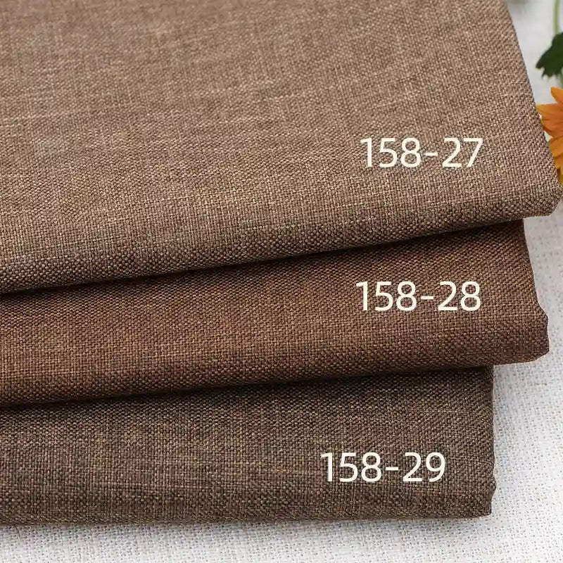 Three stacked pieces of Longan Craft Faux Linen Upholstery Fabric in brown polyester: shade 158-27 on top, 158-28 in the middle, and 158-29 at the bottom—perfect for reupholstering chairs, sofas, or curtains.