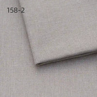 Two pieces of Longan Craft Faux Linen Upholstery Polyester Fabric are stacked, with the top piece slightly folded and code 158-2 in the upper left corner. Ideal for reupholstering chairs, sofas, or curtains. Color: light gray.