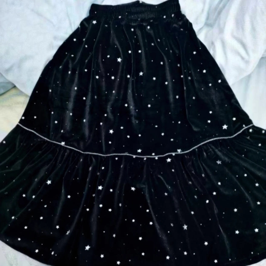 A black velvet skirt with tiered layers and white star prints inspires your next handmade look—perfect for the Women’s Pleated Midi Skirt Sewing Pattern by Longan Craft. Download the free PDF pattern to start sewing!.