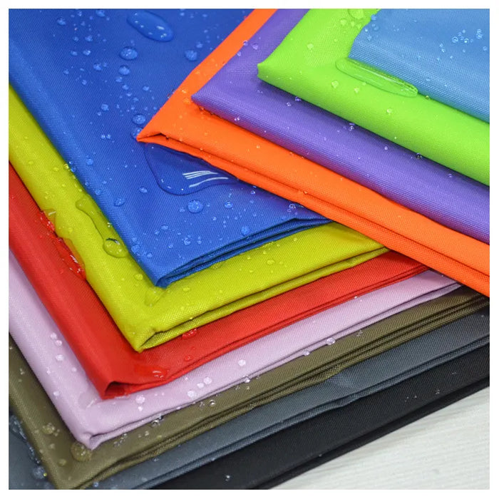 A stack of colorful, folded Longan Craft 300D Polyester Oxford Fabric by the Yard, sunproof and waterproof with silver coating. Available in blue, green, orange, red, pink, beige, gray, and black—ideal for tents and awnings.