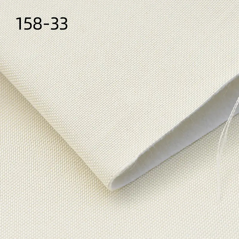 A close-up of Longan Craft Faux Linen Upholstery Fabric in light beige shows its textured weave, folded neatly. “158-33” appears in black at the top left. This durable polyester fabric is ideal for furniture, chairs, sofas, and curtains by the yard.