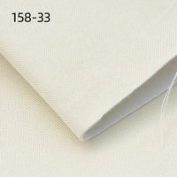 A close-up of Longan Craft Faux Linen Upholstery Fabric in light beige shows its textured weave, folded neatly. “158-33” appears in black at the top left. This durable polyester fabric is ideal for furniture, chairs, sofas, and curtains by the yard.