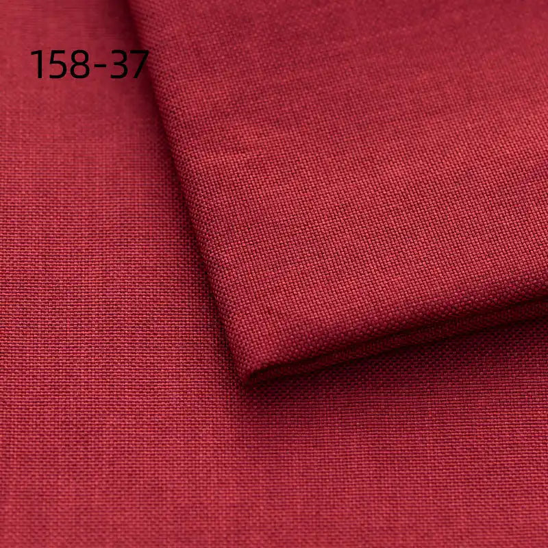 A close-up of Longan Craft's Faux Linen Upholstery Fabric by the yard in dark red, durable polyester with a folded corner and "158-37" printed in black at the upper left. Ideal for upholstering furniture or reupholstering chairs, sofas, and curtains.