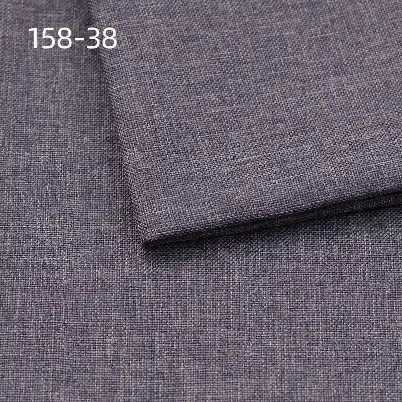 Close-up of Longan Craft Faux Linen Upholstery Fabric in dark gray, featuring a subtle textured weave. The code 158-38 is shown in white in the top left corner. Polyester fabric, ideal for upholstering furniture and reupholstering chairs, sofas, or curtains.