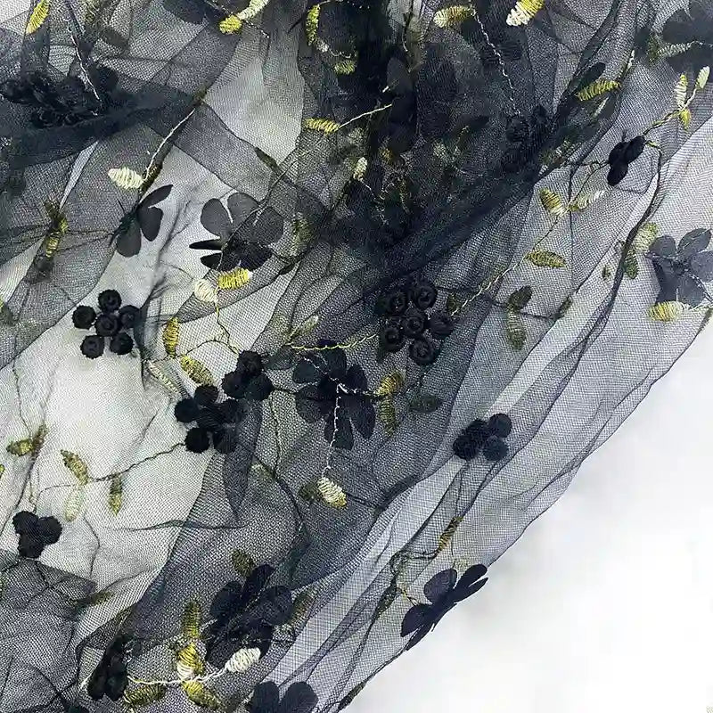 Longan Craft’s 3D Floral Embroidered Tulle Fabric By The Yard features colorful botanical embroidery, perfect for bridal or occasion dresses. This elegant tulle material is displayed on a flat surface.