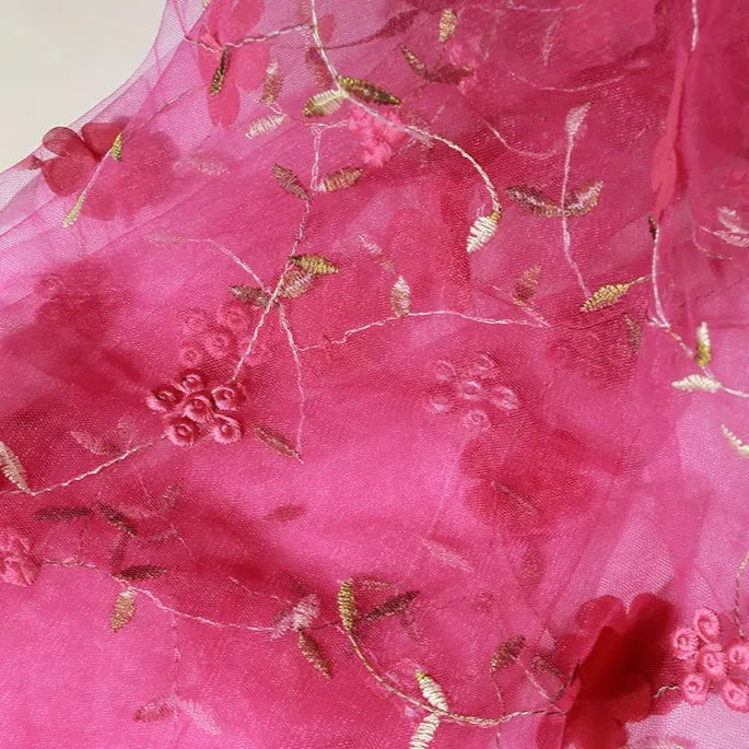Longan Craft's 3D Floral Embroidered Tulle Fabric By The Yard features lightweight, sheer pink tulle with gold and pink botanical embroidery—perfect for creating romantic bridal gowns and other elegant projects.