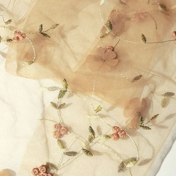 Longan Craft’s 3D Floral Embroidered Tulle Fabric By The Yard features colorful botanical embroidery on sheer tulle, ideal for wedding dresses or bridal gowns. This soft, translucent material adds elegance to any special occasion creation.