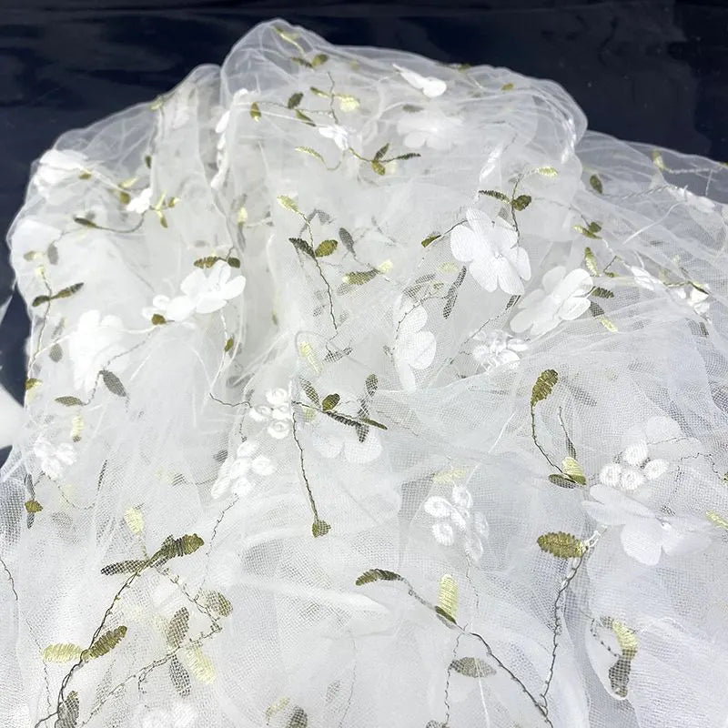 Longan Craft’s 3D Floral Embroidered Tulle Fabric By The Yard showcases colorful botanical embroidery, making it ideal for elegant bridal gowns or special occasion dresses that need a vibrant, airy touch.