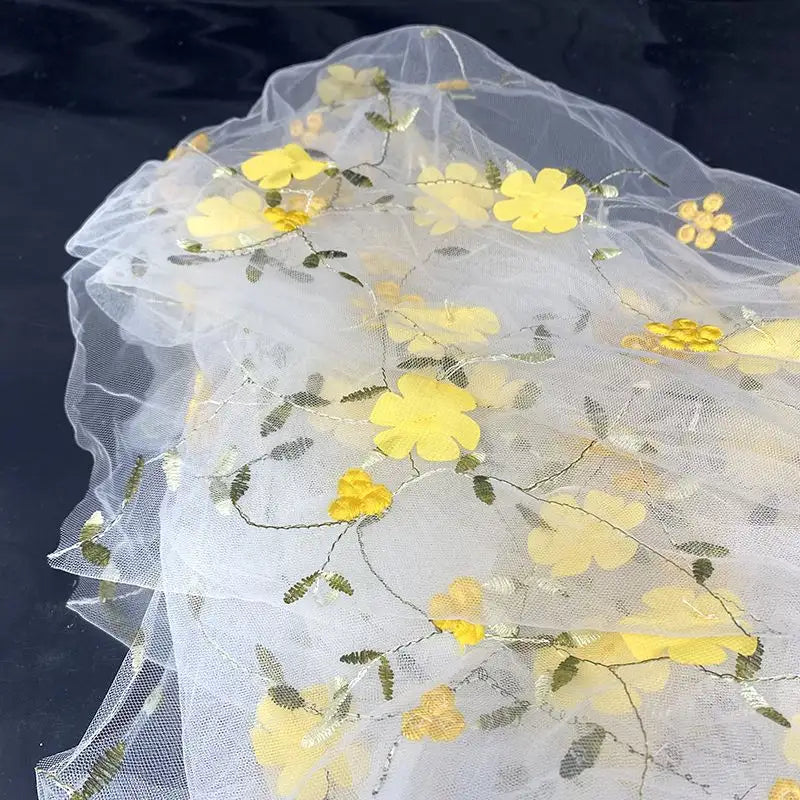 Longan Craft’s 3D Floral Embroidered Tulle Fabric by the yard features colorful botanical embroidery—ideal for bridal gowns or special dresses. This sheer tulle with vibrant flowers and leaves adds elegance to any occasion.
