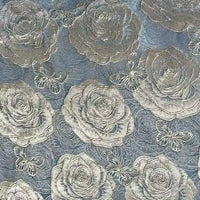 The 3D Rose Butterfly Brocade Fabric by Longan Craft features silvery jacquard roses and butterflies on a light blue background, creating an elegant, textured look—ideal for dresses and perfect for adding sophistication to your projects.