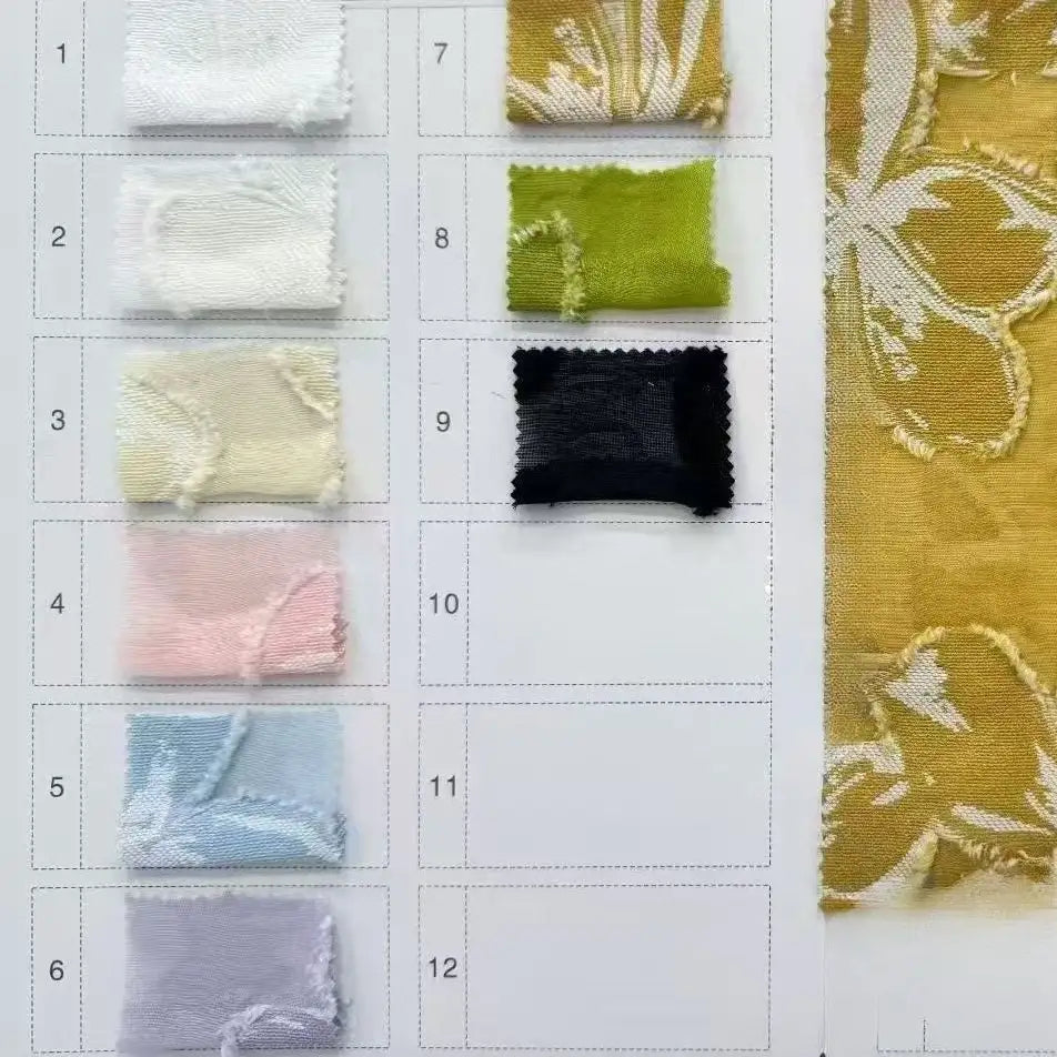 The Longan Craft 3D Floral Patchwork Rayon Fabric swatch card features nine colorful textured samples plus a large sample of their soft green rayon fabric with an elegant flower pattern, ideal for dresses.
