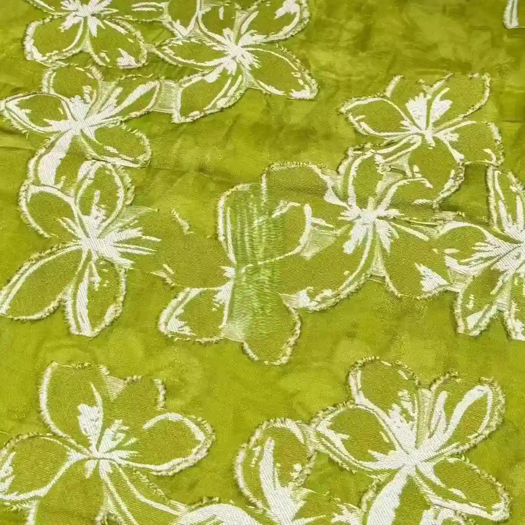 The 3D Floral Patchwork Rayon Fabric by Longan Craft features large white flower patterns on green soft rayon, with intricate stitching for a stunning textured look—ideal for dresses.