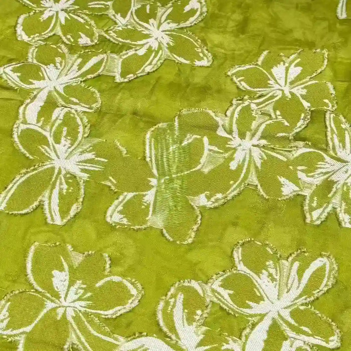 The 3D Floral Patchwork Rayon Fabric by Longan Craft features large white flower patterns on green soft rayon, with intricate stitching for a stunning textured look—ideal for dresses.